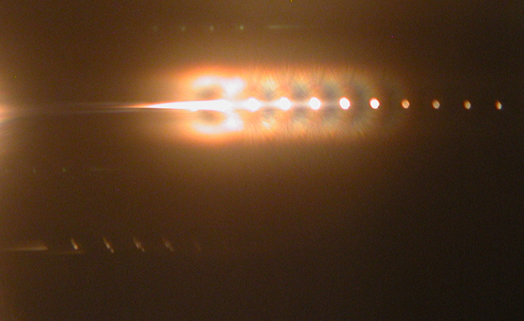 The Chaos of a Dripping Faucet Creates an Ordered In-Fiber Photonics