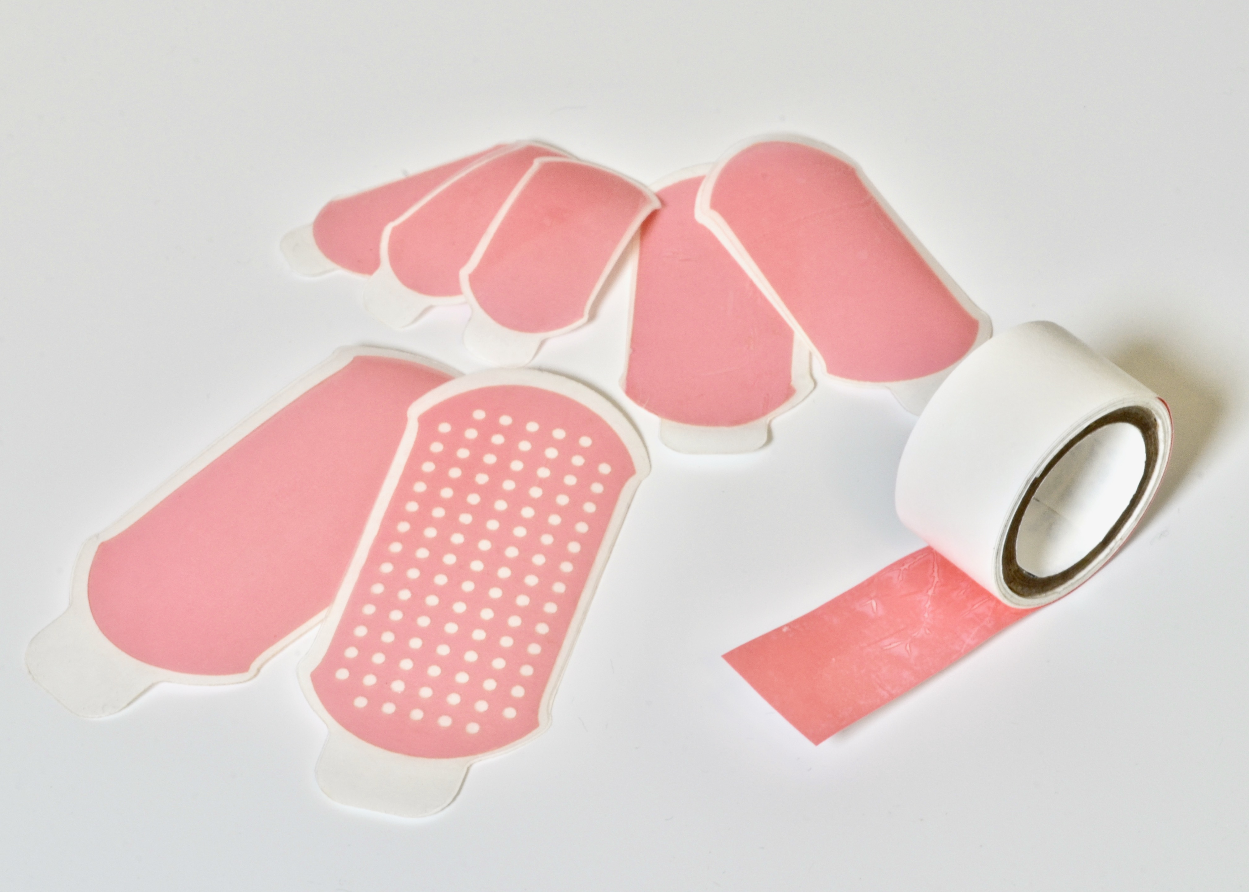 Dry double-sided tape for adhesion of wet tissues and devices